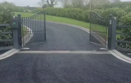driveway drainage channels installed below a gate