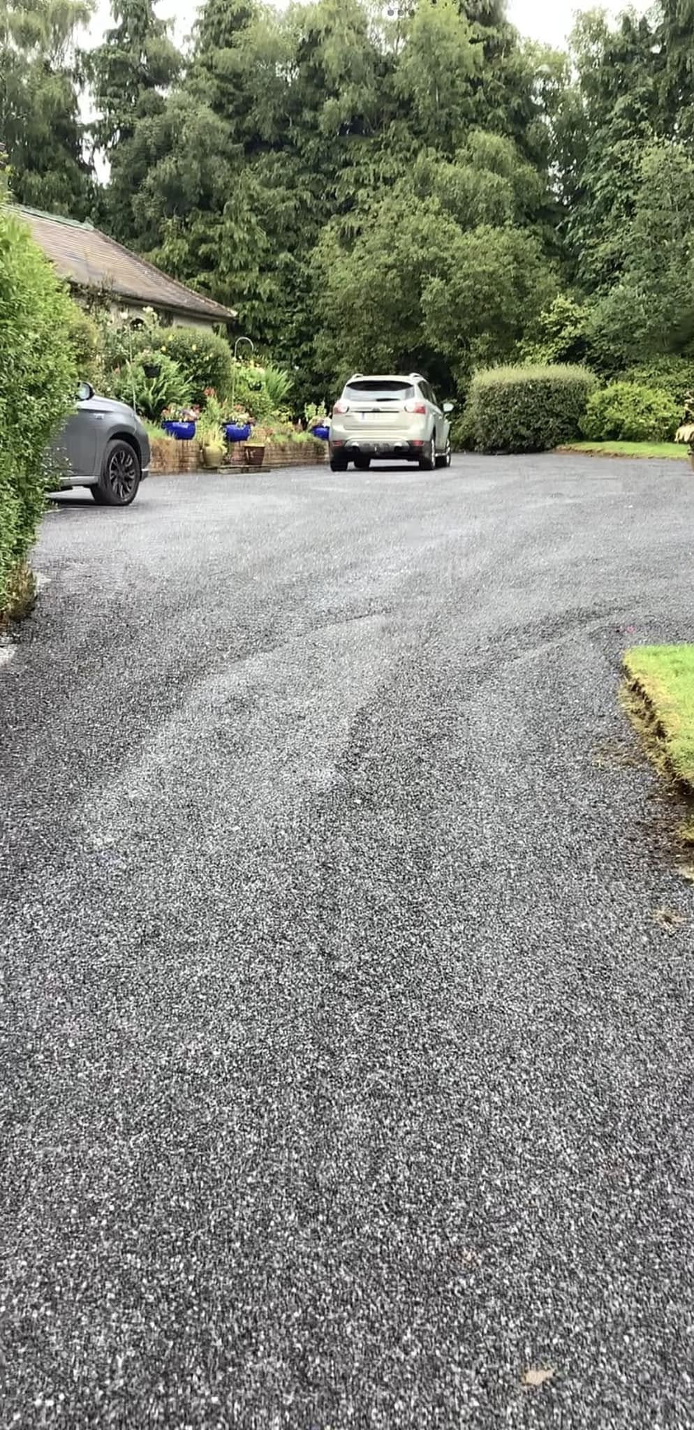 car driving on a tar and chip driveway